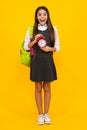 School and education concept. Back to school. Schoolchild, teenage student girl with clock alarm, time to study. Excited