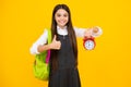 School and education concept. Back to school. Schoolchild, teenage student girl with clock alarm, time to study. Happy Royalty Free Stock Photo