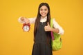 School and education concept. Back to school. Schoolchild, teenage student girl with clock alarm, time to study. Happy Royalty Free Stock Photo