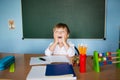 School and education concept. Little children at school lesson. Happy student writing in notebook in school classroom Royalty Free Stock Photo