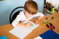 School and education concept. Little children at school lesson. Happy student writing in notebook in school classroom Royalty Free Stock Photo