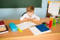 School and education concept. Little children at school lesson. Happy student writing in notebook in school classroom Royalty Free Stock Photo