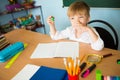 School and education concept. Little children at school lesson. Happy student writing in notebook in school classroom Royalty Free Stock Photo