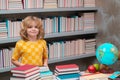 School and education concept. Schoolboy reading book in library. Kids development, learn to read. Pupil reading books in Royalty Free Stock Photo