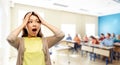 Stressed asian woman holding to her head at school