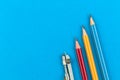 School equipment fot the first day, concept, flat lay background with pencils and drawing compass on blue office desk Royalty Free Stock Photo