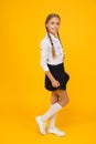 School fashion style. smart looking student yellow background. modern education concept. back to school. little girl in