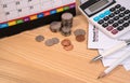 School fee past due final notice letter, education fee, desk calendar, calculator, money coin, pen and pencil on wooden table.