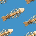 School of fish concept, pattern with toy fishes handmade from old pieces of wood swimming on blue Royalty Free Stock Photo