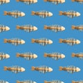 School of fish concept, pattern with toy fishes handmade from old pieces of wood swimming on blue Royalty Free Stock Photo