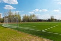 School football field with artificial turf against a blue sky Royalty Free Stock Photo