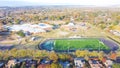 School football field with running track, soccer goal and residential neighborhood in horizontal line Royalty Free Stock Photo