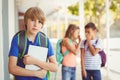 School friends bullying a sad boy in corridor Royalty Free Stock Photo