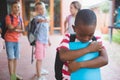 School friends bullying a sad boy in corridor Royalty Free Stock Photo