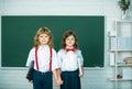 School friends. Two school kids, girl and boy holding hands going at school class in first class. Royalty Free Stock Photo