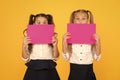 School friendship. Girls school uniform hold poster. School girls show poster. Social poster copy space. Socialization