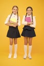 School friendship. Schoolgirls wear school uniform. Knowledge day. School day. Girl with copy books or workbooks. Study