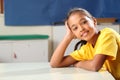 School girl 10 relaxed while sitting at her classr