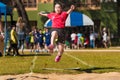 School girl athlete jump up high at school`s track and field lon Royalty Free Stock Photo
