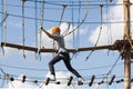 school girl climbs in an adventure rope park