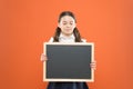 School girl cute pupil hold blackboard copy space. School announcement concept. Informing kids changes in school life