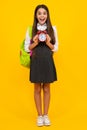 School girl and education concept. Back to school. Schoolchild, teenage student girl with clock alarm, time to study Royalty Free Stock Photo