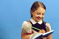 School girl with happy face isolated on blue background Royalty Free Stock Photo