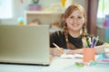 School girl having distance education at home in sunny day Royalty Free Stock Photo