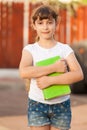 School Girl Holds A Green Book