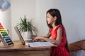 School girl at home on distance education, homeschooling and doing homework at laptop. E-learning, web lesson concept Royalty Free Stock Photo