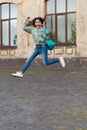 school girl jump childhood outside, college. school girl jump childhood at the street.