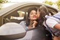 School girl kisses her mother before entering class. Young mother in the car, leaving her daughter at school Royalty Free Stock Photo