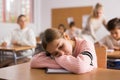 School girl lying and sleeping at desk Royalty Free Stock Photo