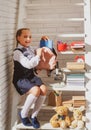 School girl preparing backpack for school. Education for kids. Back to school. Little schoolgirl collecting books in a Royalty Free Stock Photo