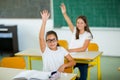 School girl raised hands in class Royalty Free Stock Photo