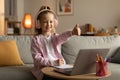 School Girl Showing Thumbs Up To Laptop Wearing Headset Indoor Royalty Free Stock Photo