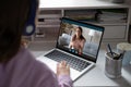 School girl student studying with online teacher on computer screen