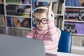 School girl is studying online. Home schooling. Distance education. The girl raises her hand to answer the teacher Royalty Free Stock Photo