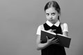 School girl with thoughtful face on blue background Royalty Free Stock Photo