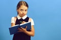 School girl with thoughtful face isolated on blue background Royalty Free Stock Photo