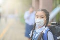 School Girl wearing mouth mask against air smog pollution in Bangkok city, Thailand