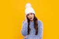 School girl in winter clothes and warm hat. Winter holiday vacation. Child fashion model. Angry teenager girl, upset and