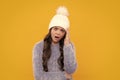 School girl in winter clothes and warm hat. Winter holiday vacation. Child fashion model. Angry teenager girl, upset and