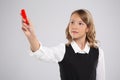 A school girl writes on a blackboard with red chalk Royalty Free Stock Photo