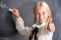 School girl writing on blackboard Royalty Free Stock Photo