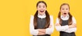 School girls friends. Learn with surprise. Surprised children keep arms crossed. Portrait of schoolgirl student, studio