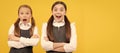 School girls friends. Learn with surprise. Surprised children keep arms crossed. Portrait of schoolgirl student, studio