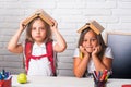 School girls. Friendship of small sisters in classroom at knowledge day. Back to school and home schooling. sad school Royalty Free Stock Photo