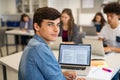 School guy working on laptop during class Royalty Free Stock Photo