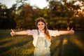 school happy girl thumbs up gesture both hands on lawn with green trees background Royalty Free Stock Photo